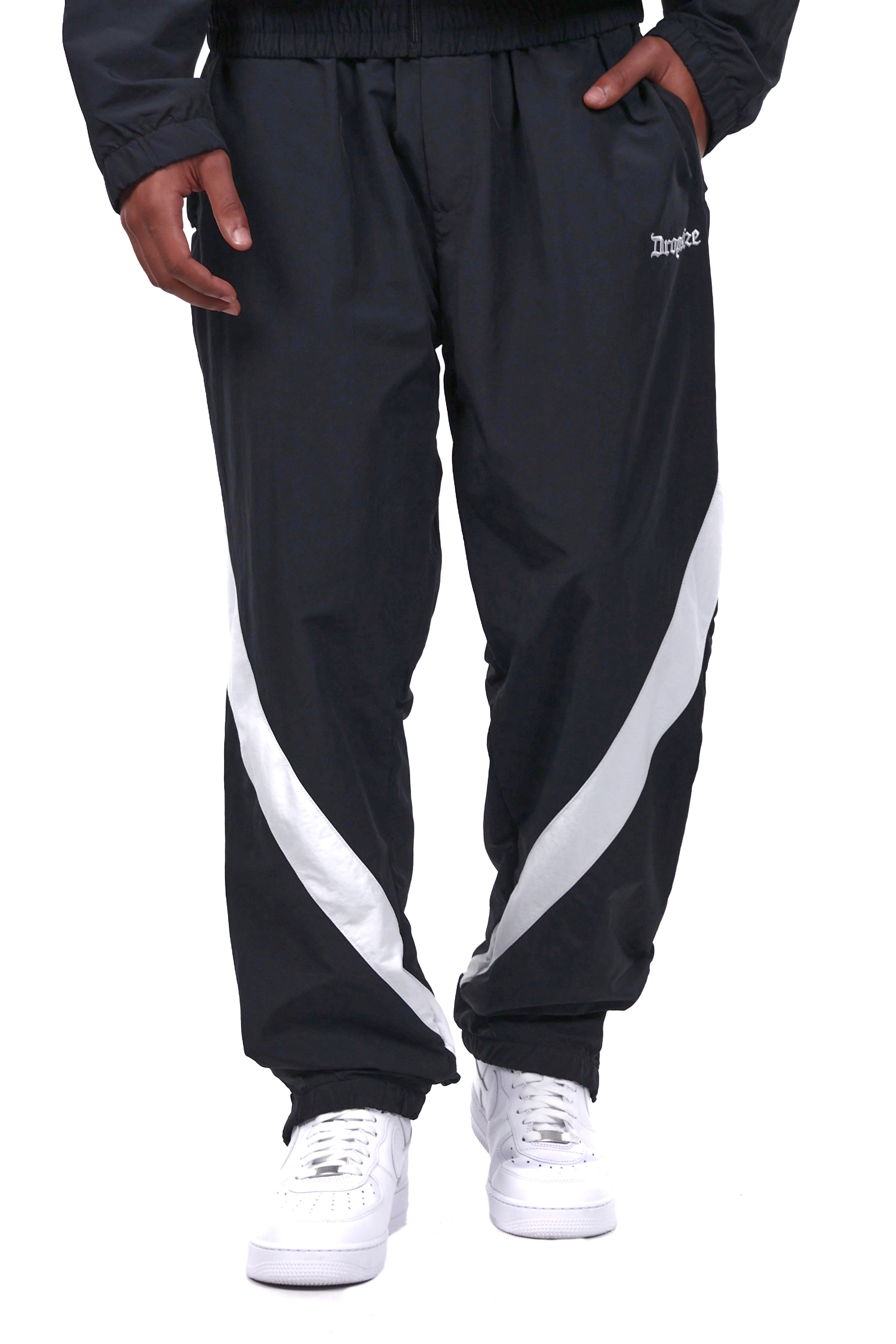 Black track pants with white stripe on sale